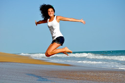 woman-jumping-on-beach