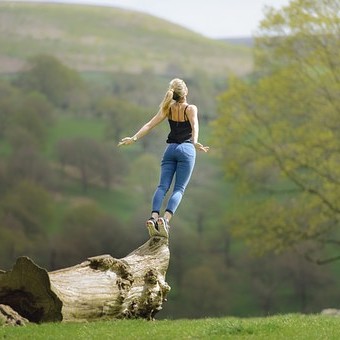 woman-ready-to-jump-from-log
